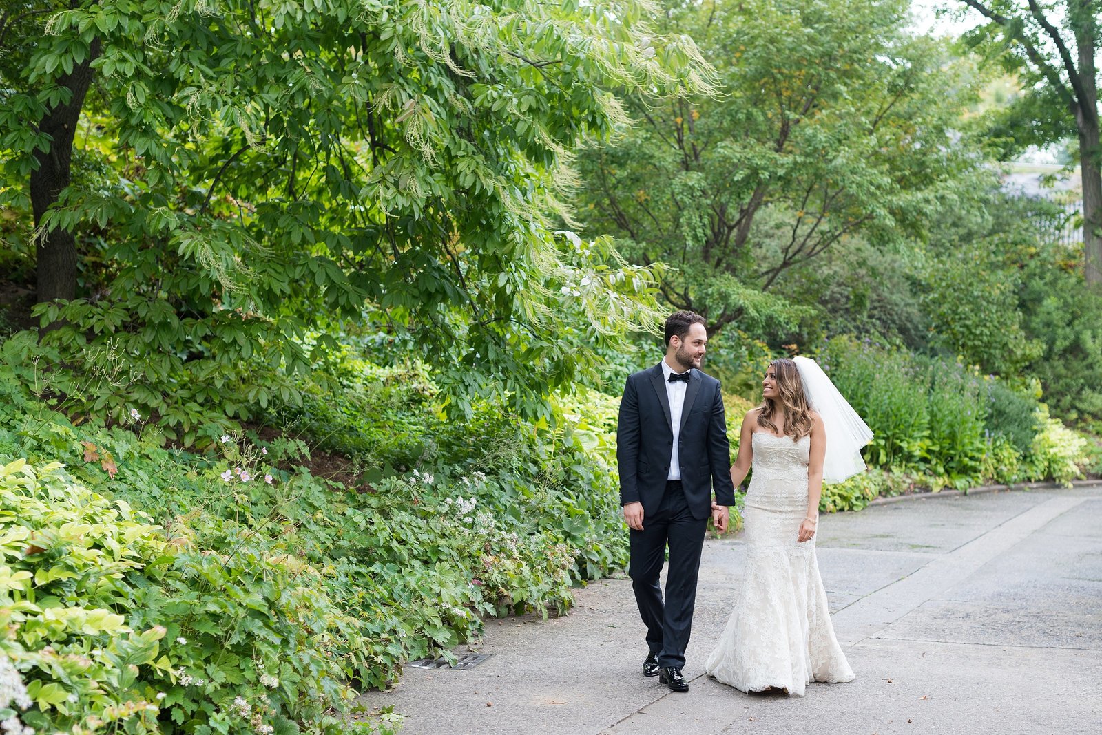 Bride and Groom looking at each other and walking at the Conservatory Garden in Central Park, New York City Photo