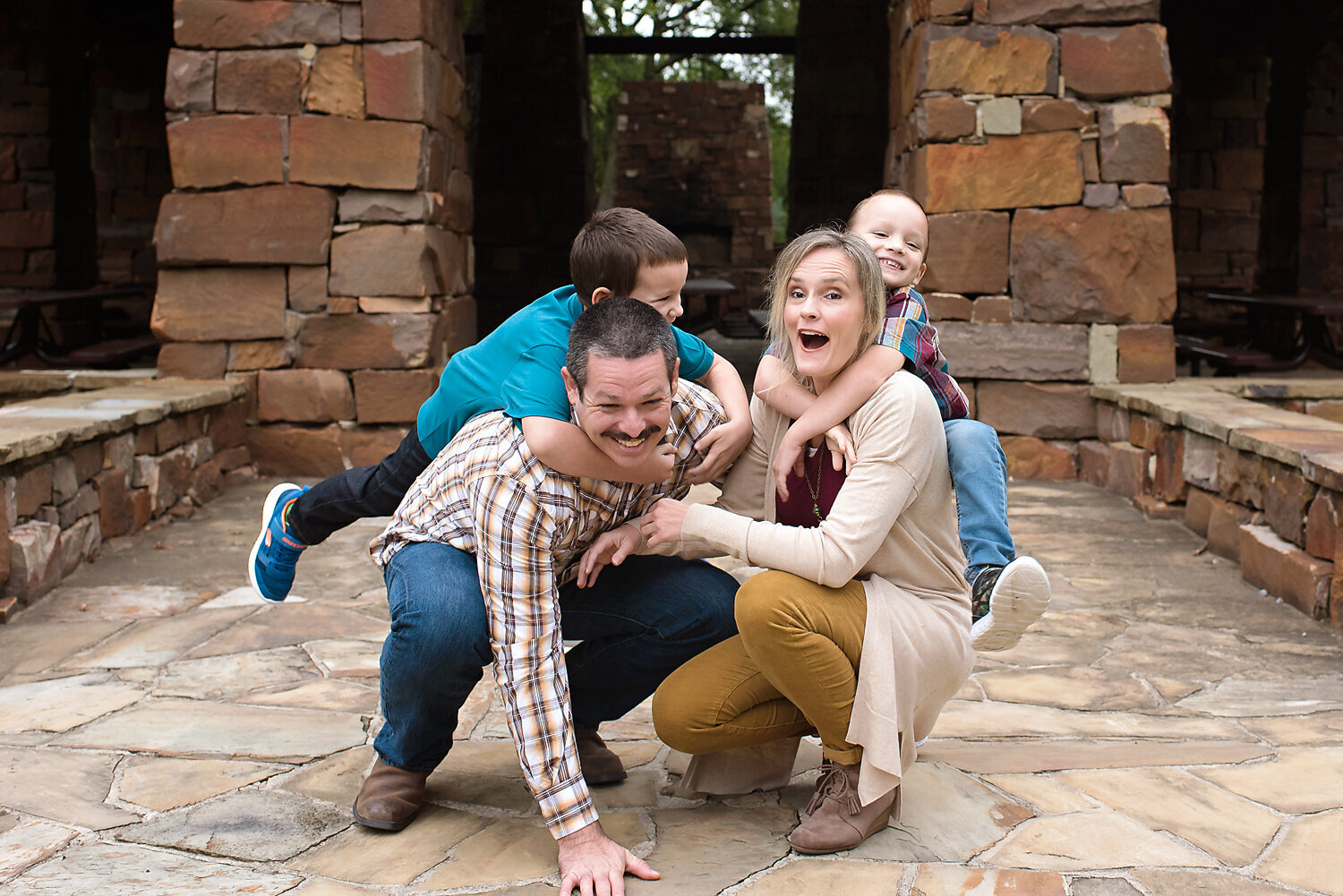 A family playing at their lifestyle family photo session at the Dayspring Nature Preserve in Allen.