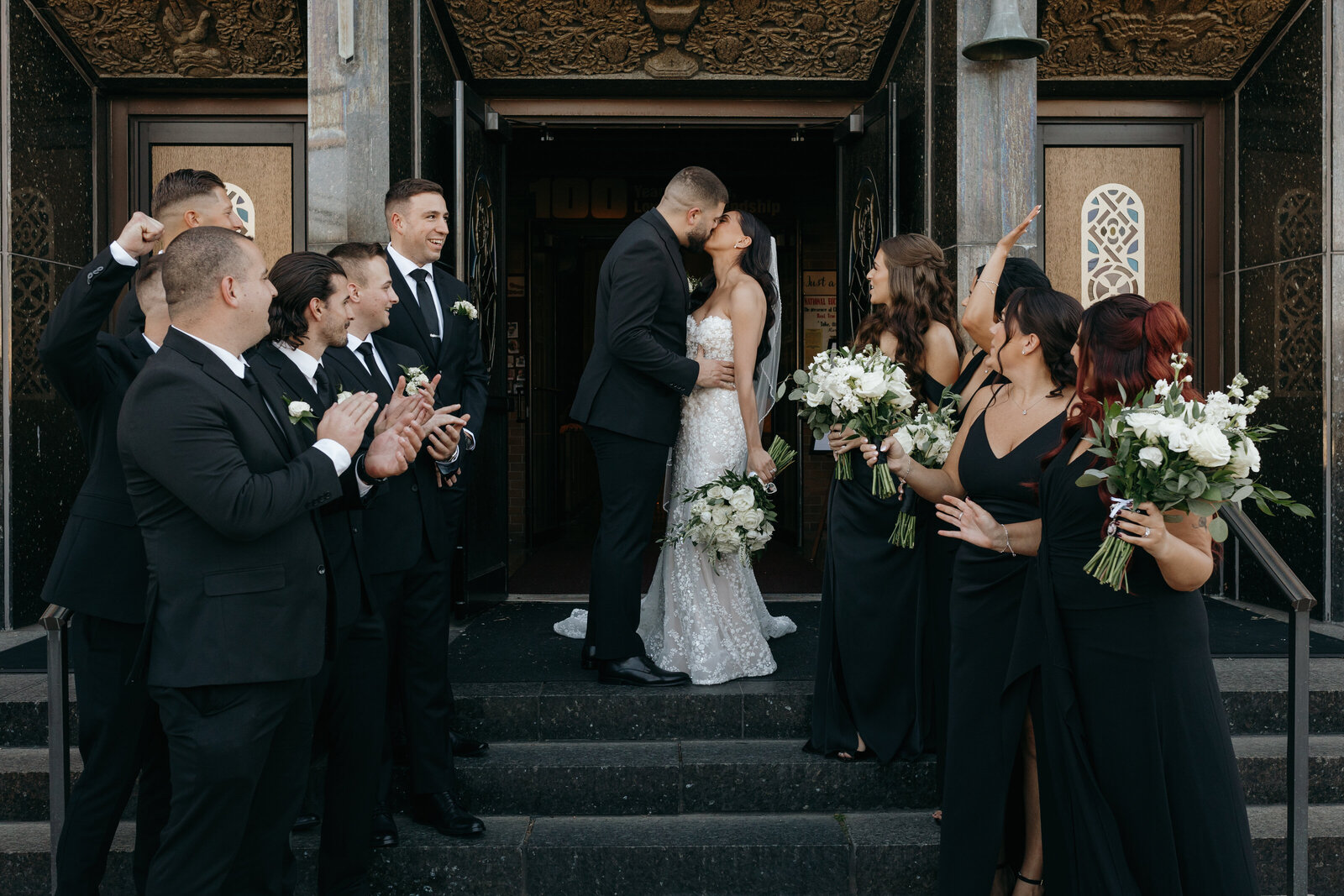 Bride and groom share a romantic kiss coming out of their chapel after being married | Emma LeeAnn Photography