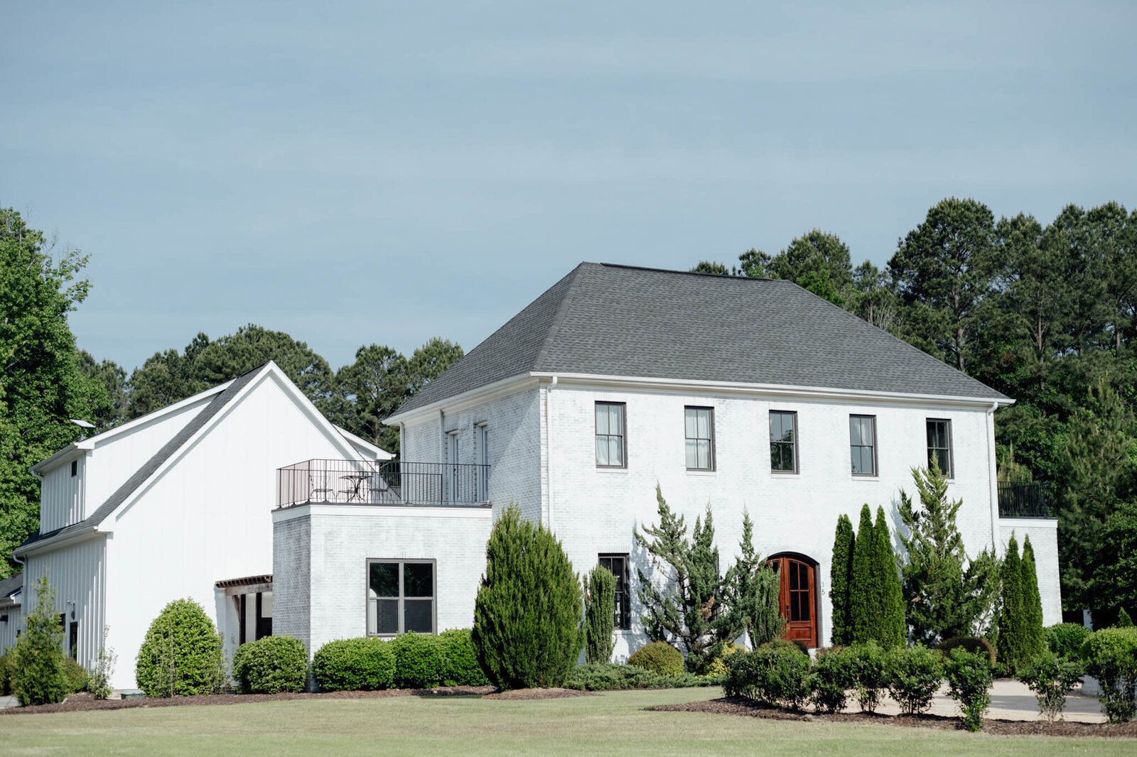 White venue building with dark roof