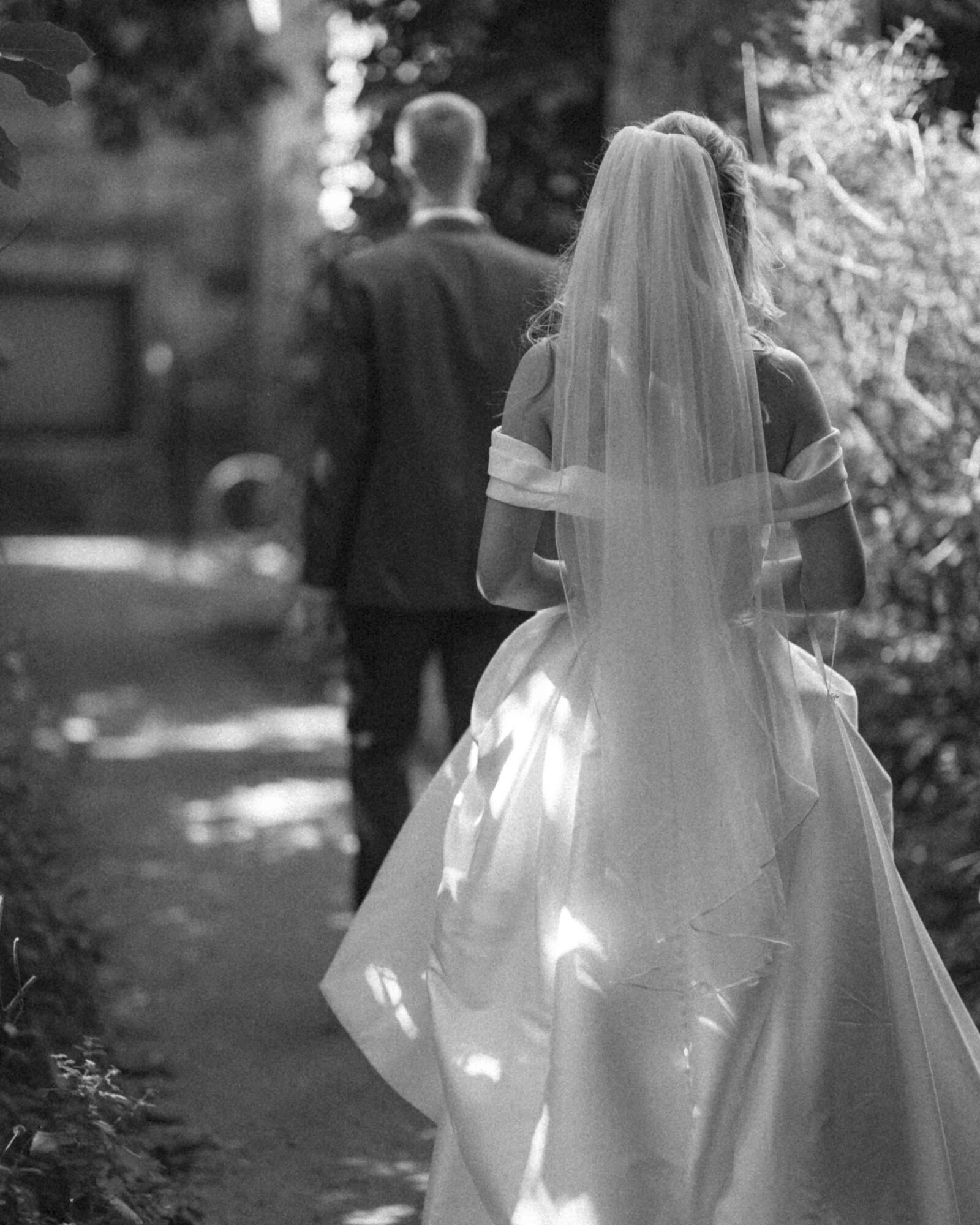black and white of bride walking away