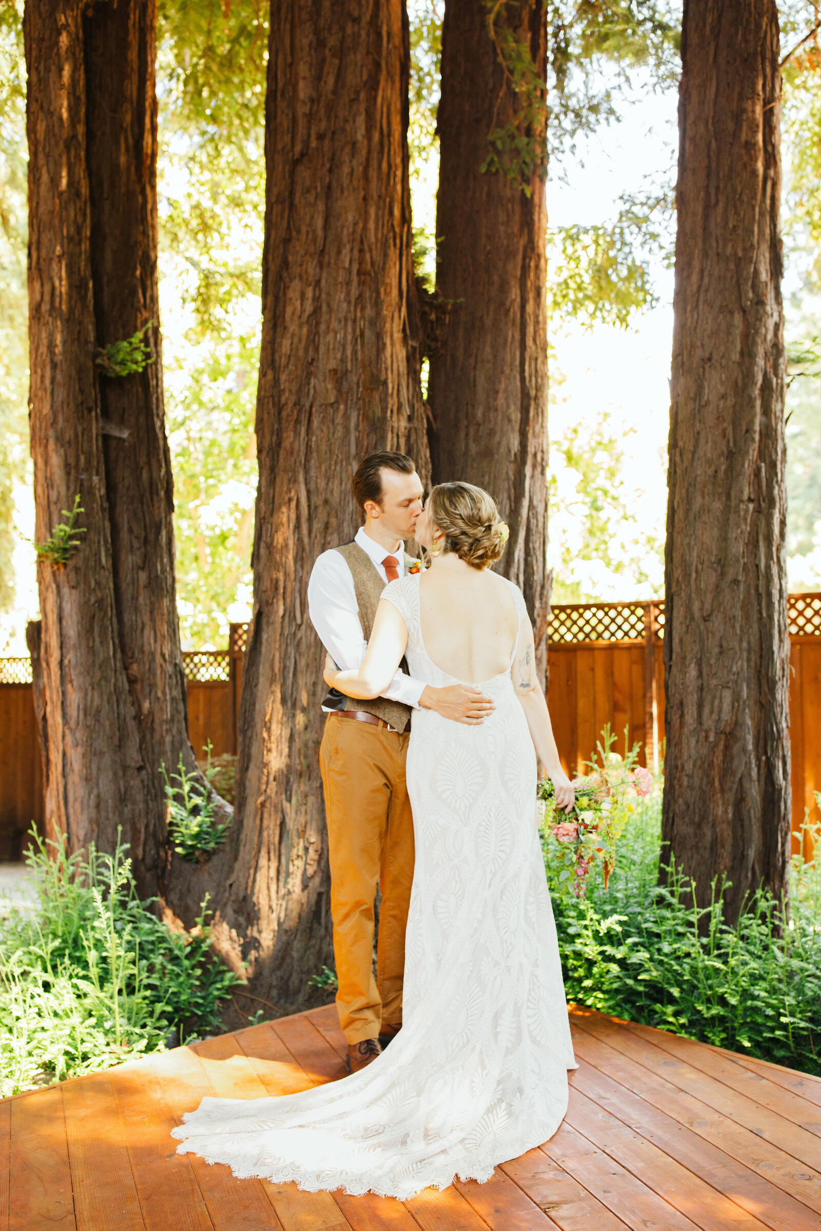 Bride and groom on their colorful wedding day in Santa Cruz, California in the redwood trees.