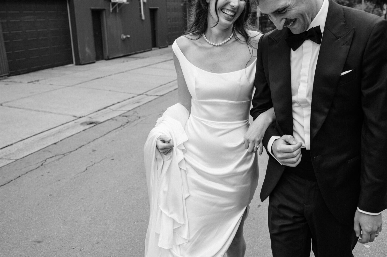 Wedding couple laughing together on Halifax street