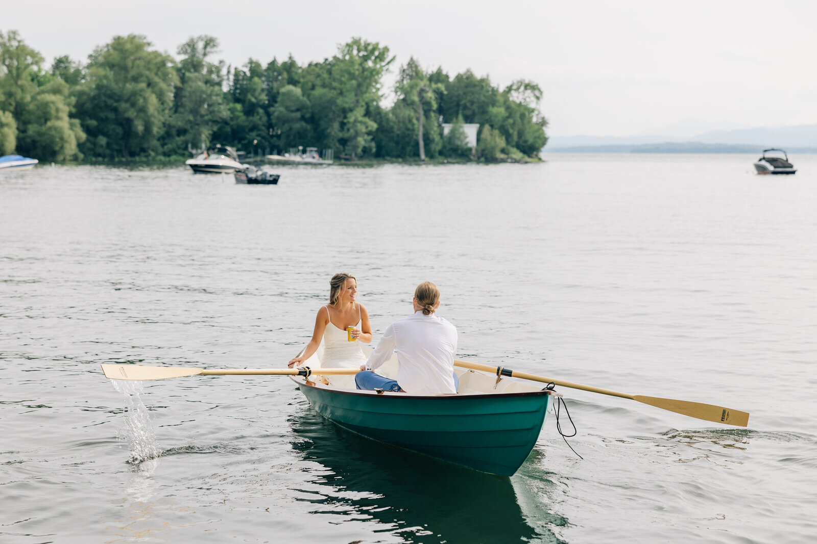 Wedding Couple in a row boat on Lake Champlain Photo Courtesy of Erin Marie Photography