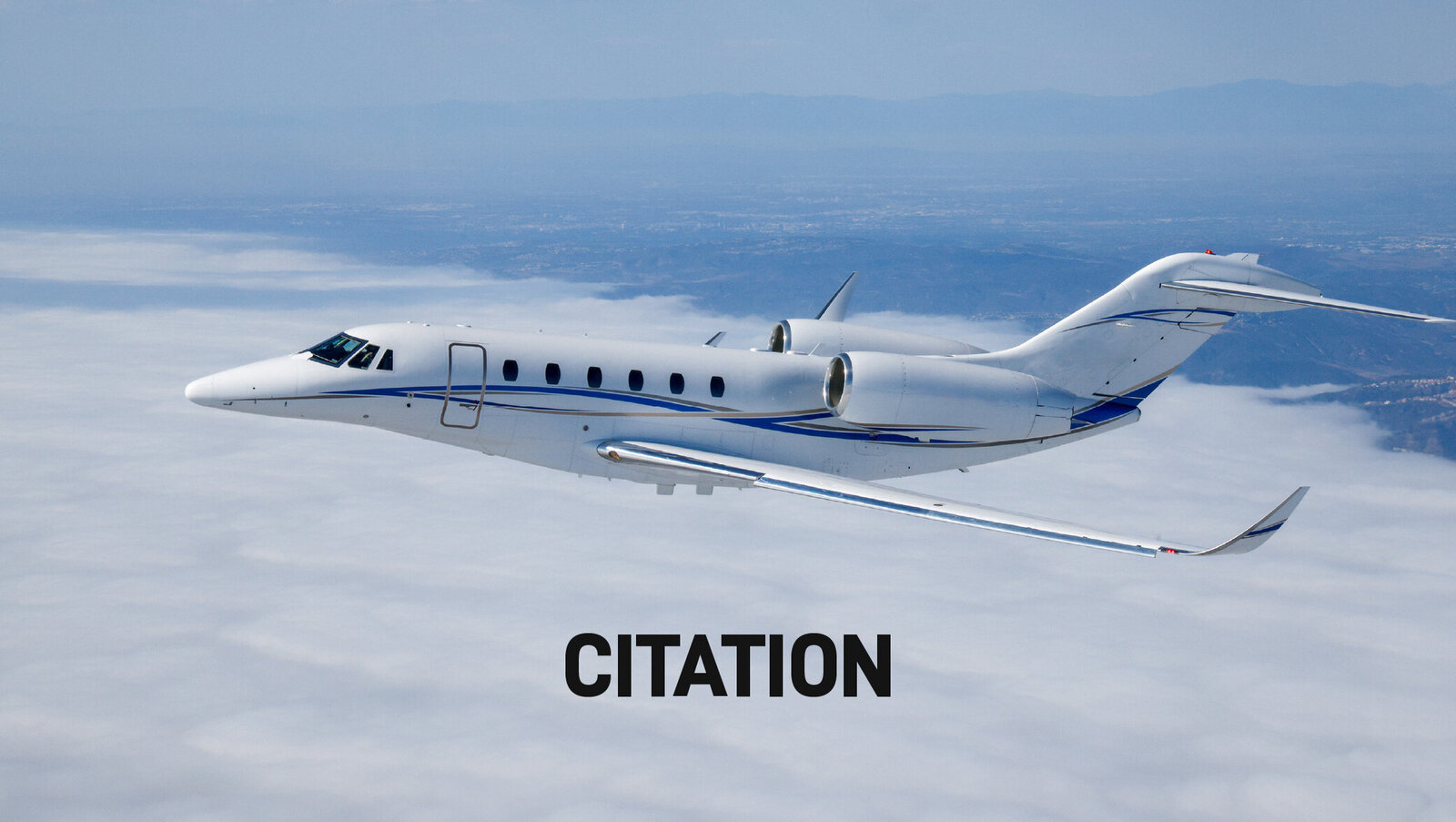 white citation jet flying through clouds and sky