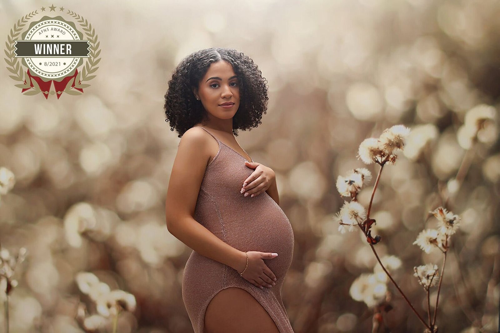 Mother-to-be in an elegant pose with soft lighting