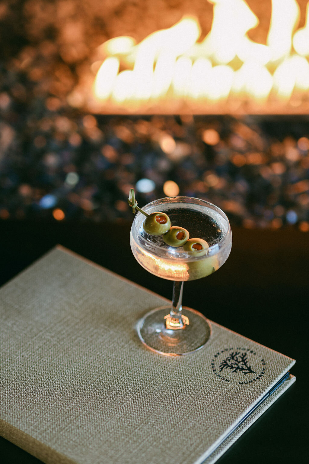martini glass by the fire at luxurious beach hotel