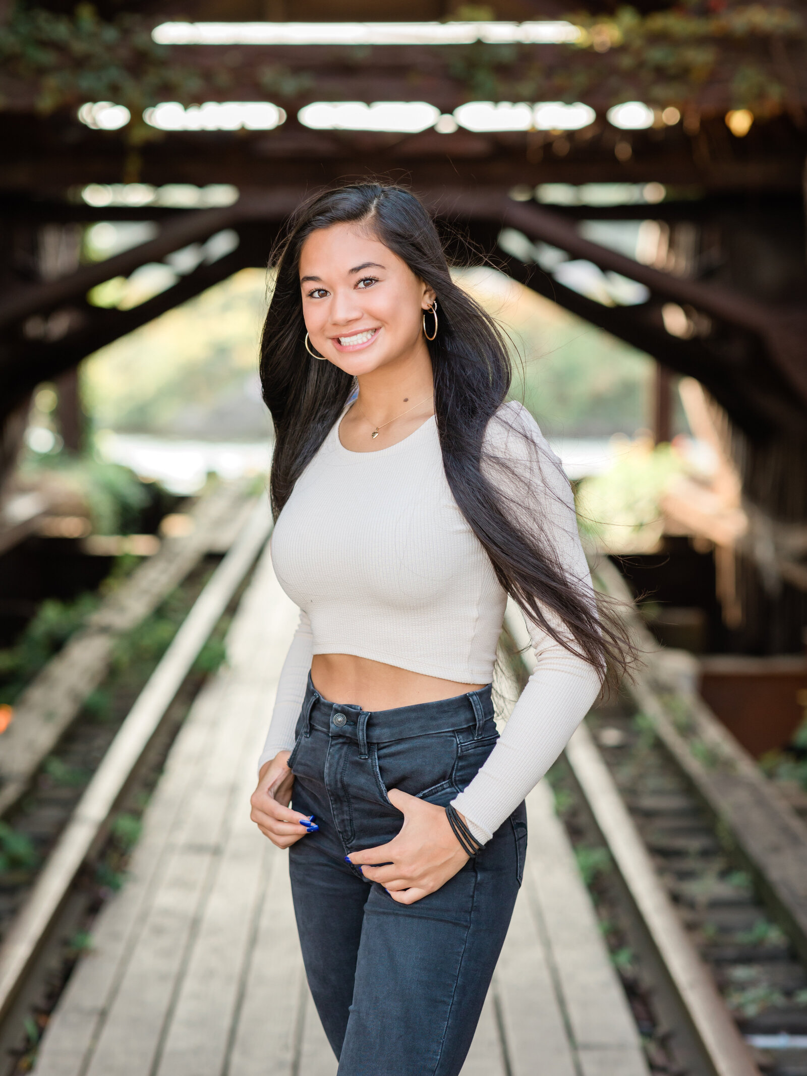 senior girl posing on shooters bridge in cleveland ohio