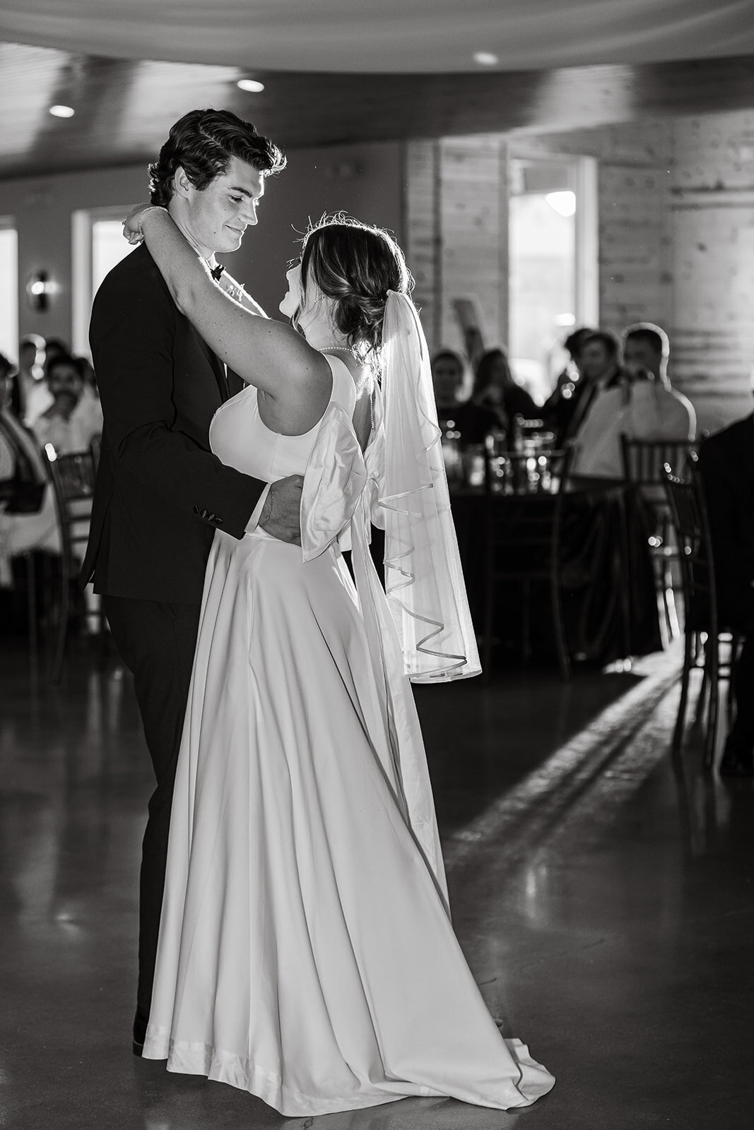 The bride and groom sharing their first dance at their wedding reception, photographed by CMH Studios in San Antonio
