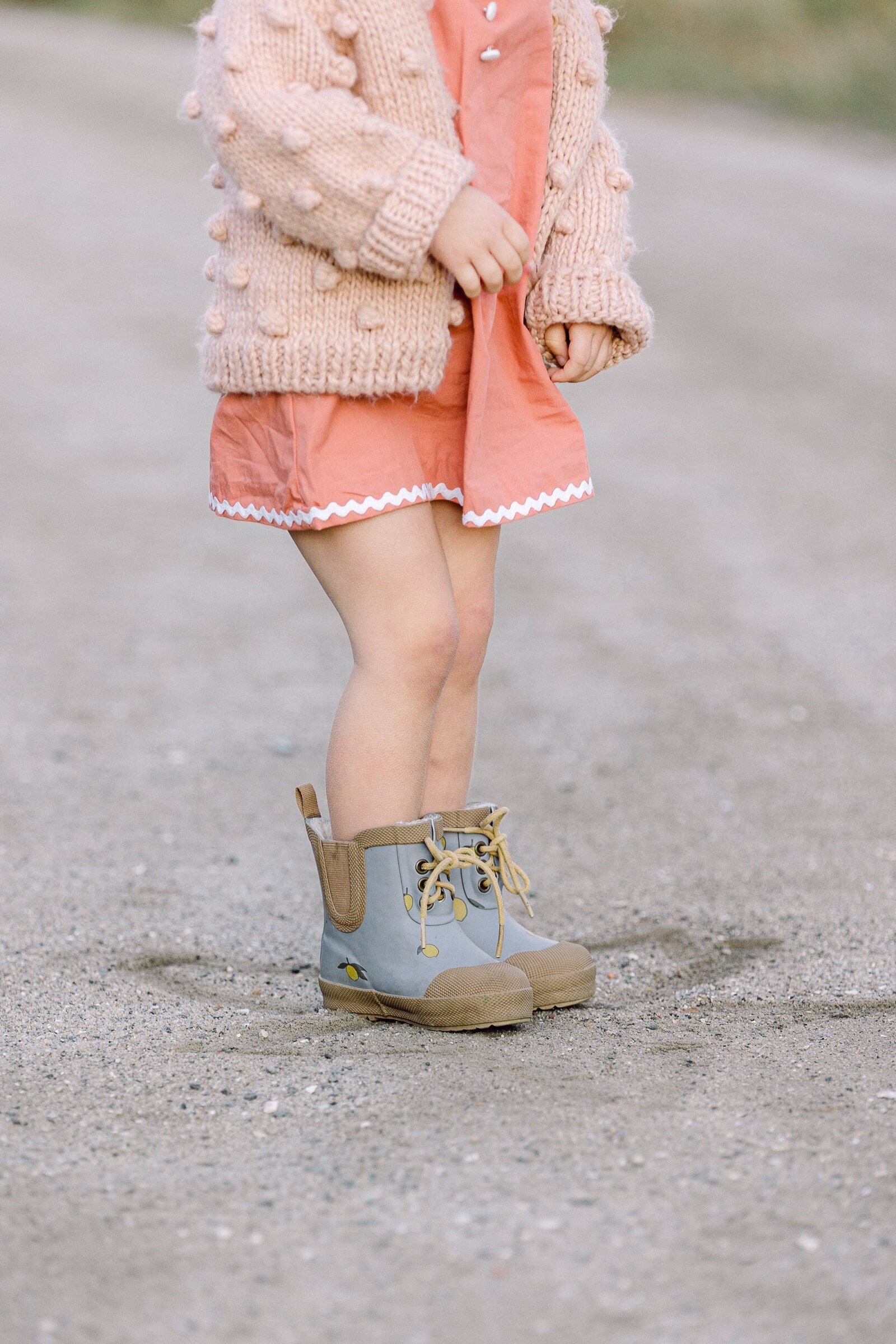 pink dress and blue boots on toddler