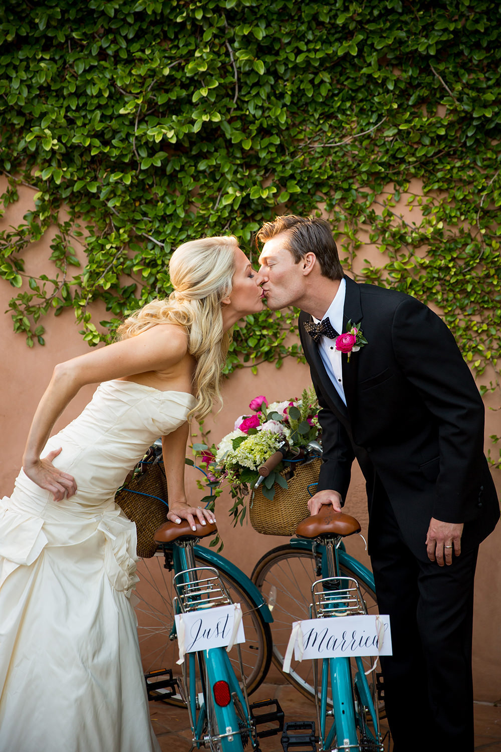 Smooching with fun bicycle wedding day props