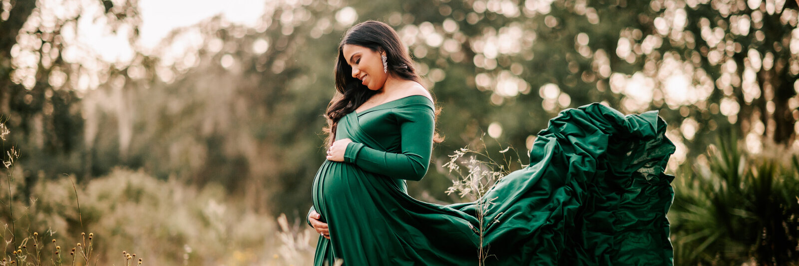 Pregnant mom in green gown at an Orlando maternity session