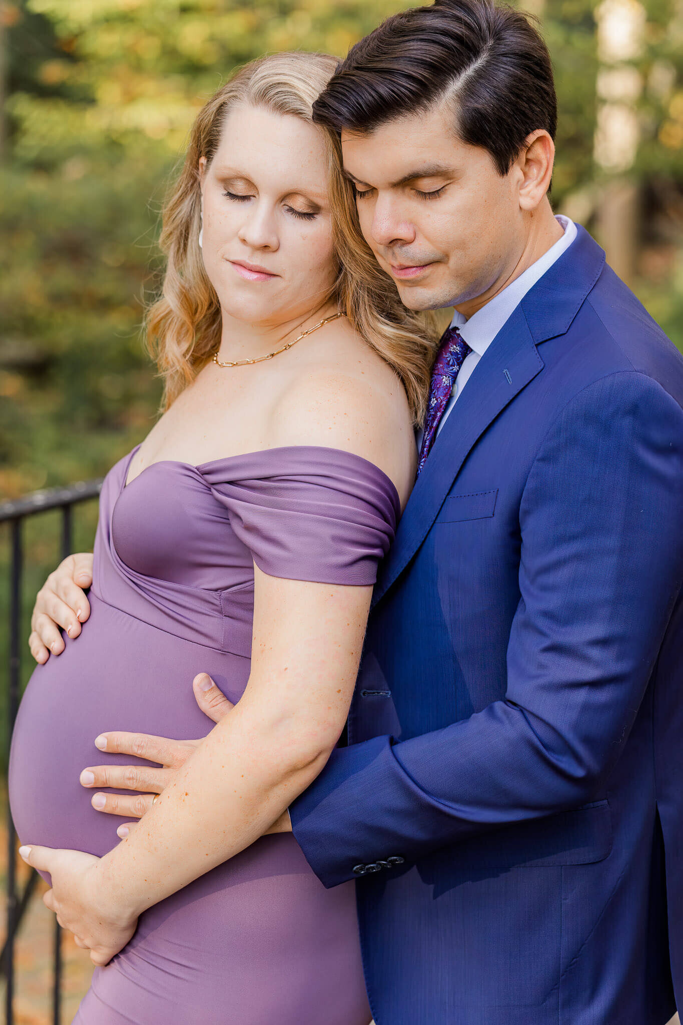 A beautiful couple embracing with their eyes closed during their Northern Virginia maternity photo session.