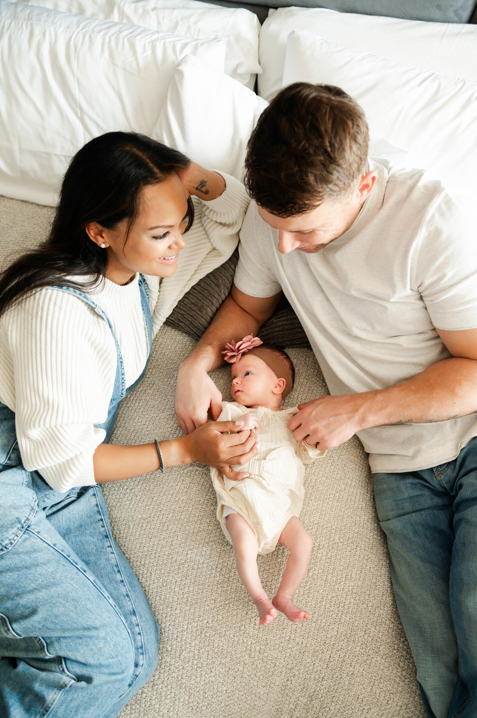 husband and wife with newborn baby girl
