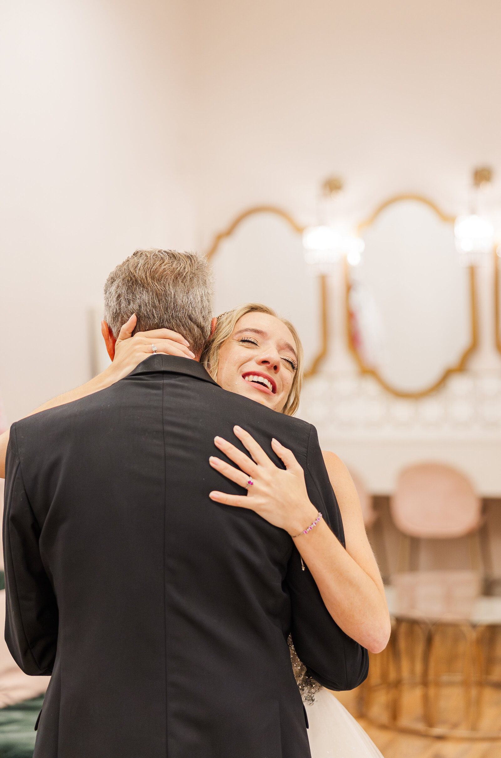 Bride-hugging-father-hand-around-his-neck