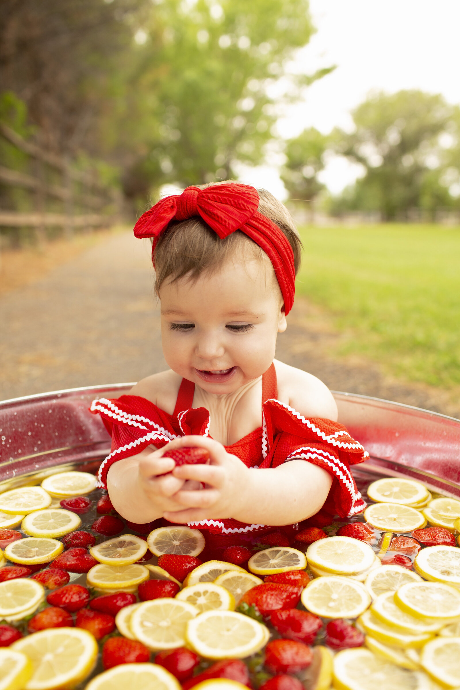 lemons-and-strawberries-one-year-old-fruit-bath-in-the-park-NM