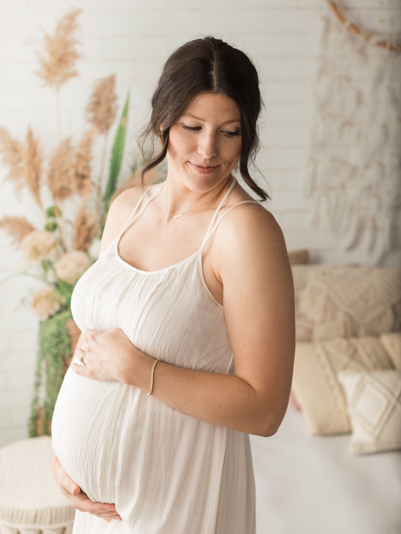 pregnant mom holding belly forboho maternity photoshoot