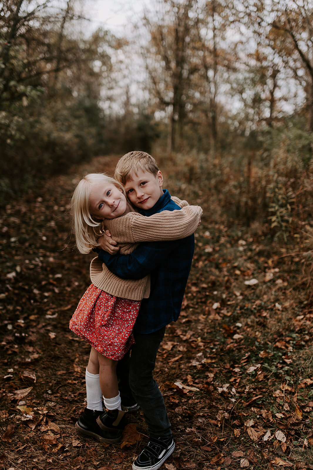 Siblings hugging on a hiking trail at French Park in Cincinnati