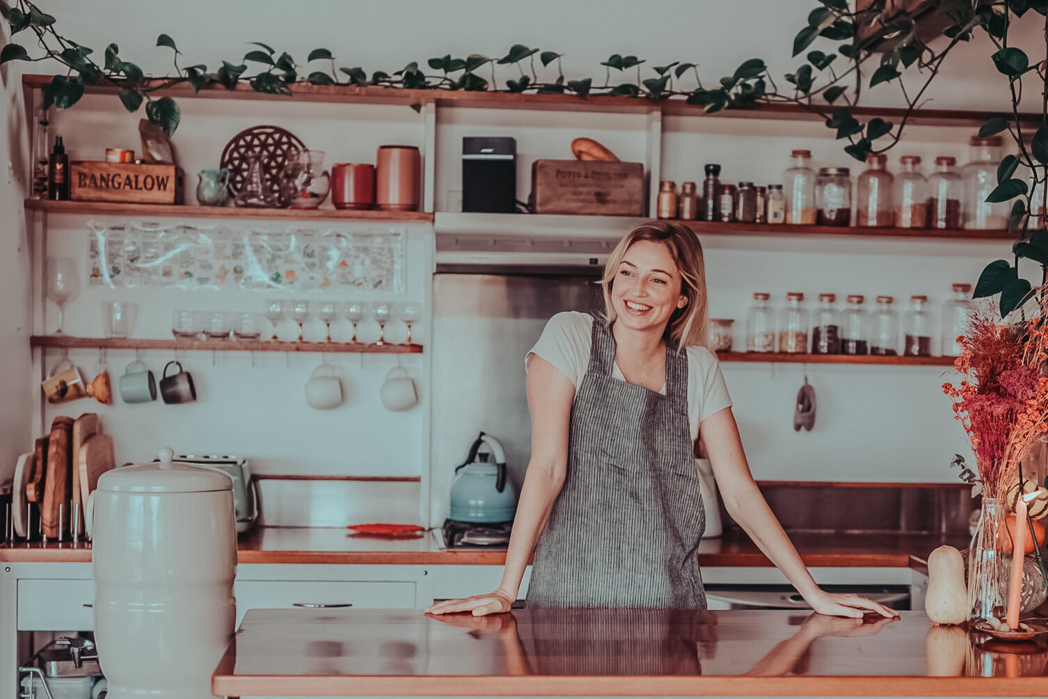 Woman chef in kitchen showing her cooking area