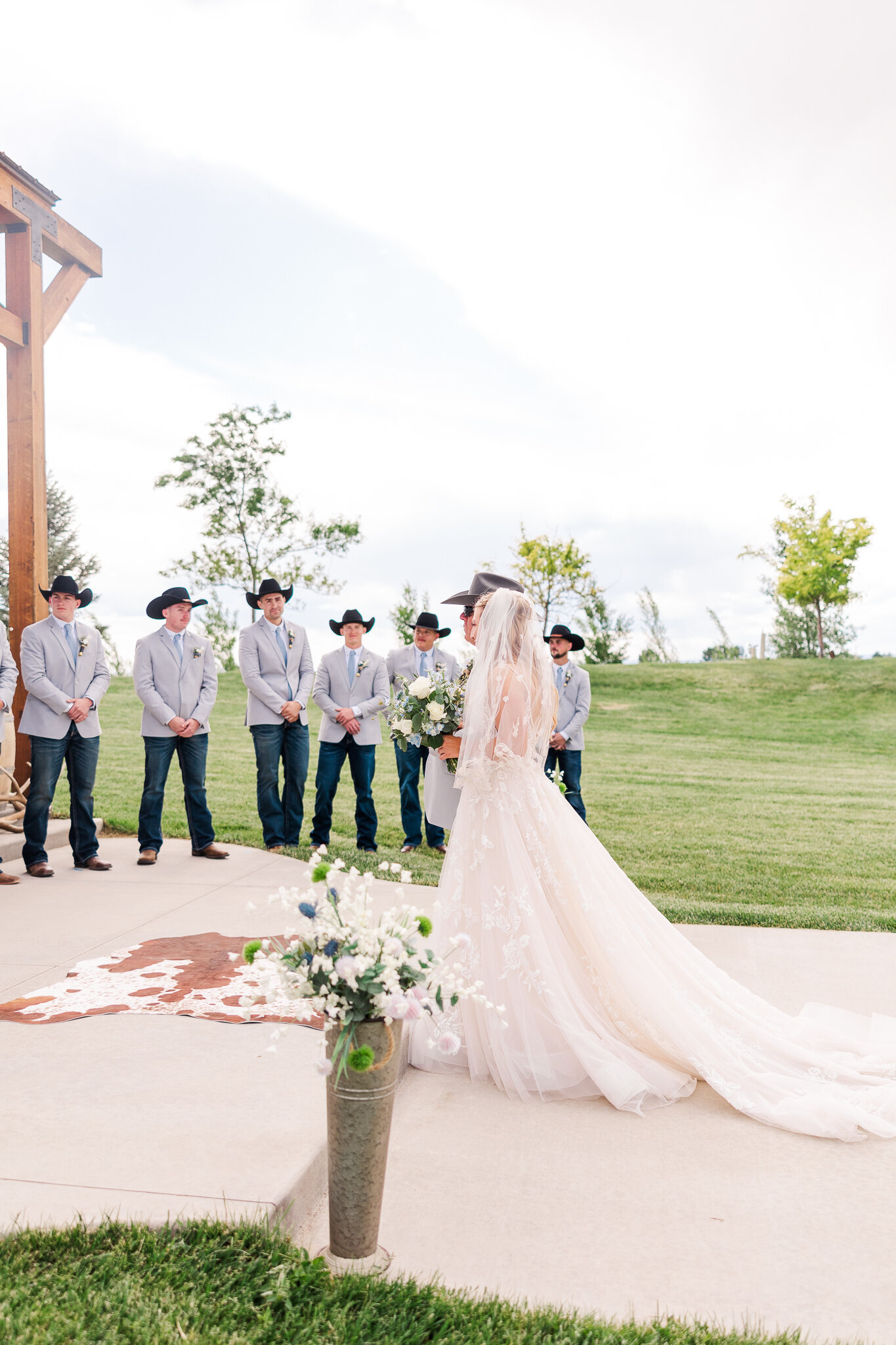Side angle view of bride’s father giving her away during the ceremony at a Loma, Colorado wedding at Absolute Prestige
