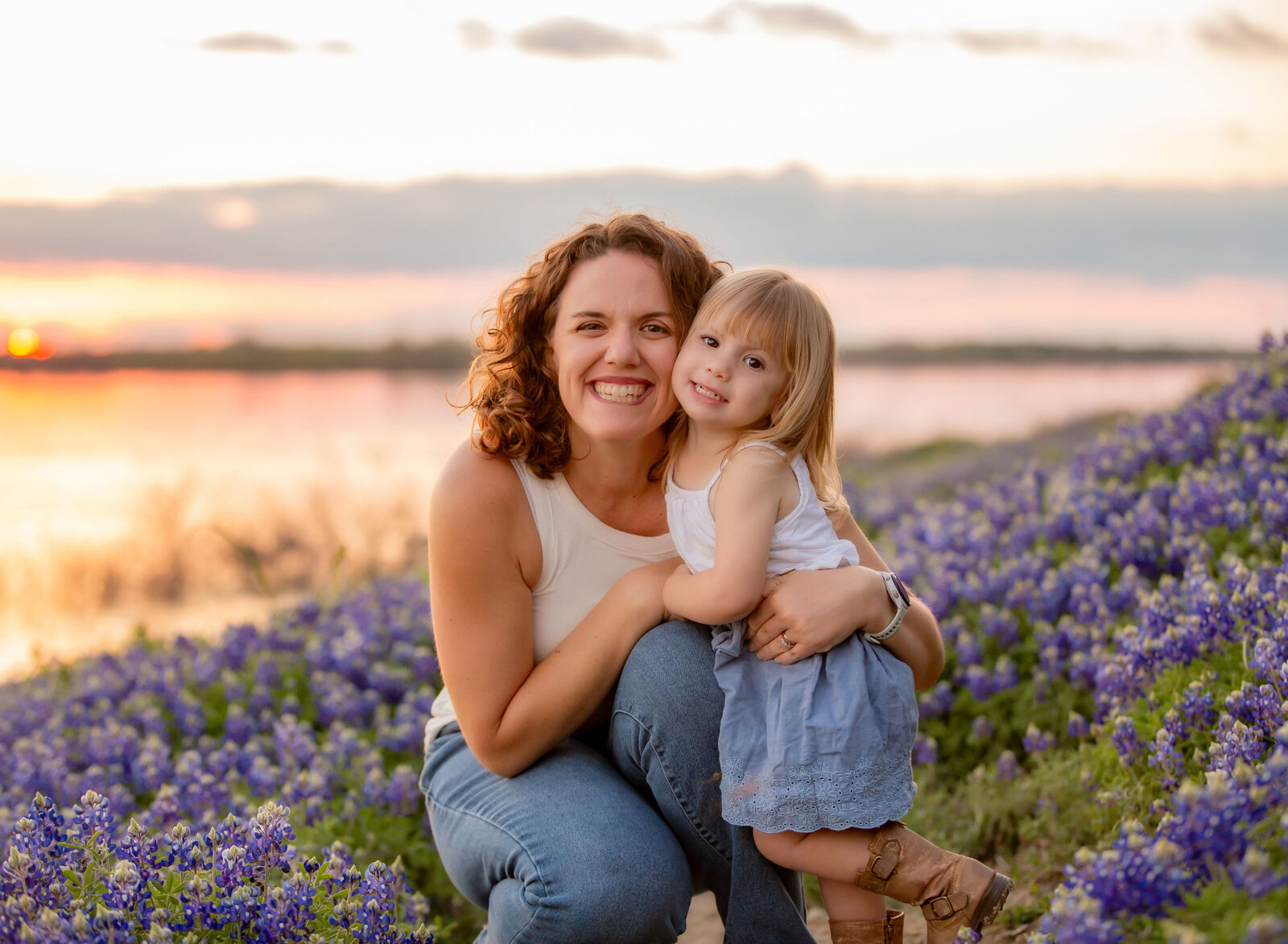 mother and daughter in bluebonnets at sunset