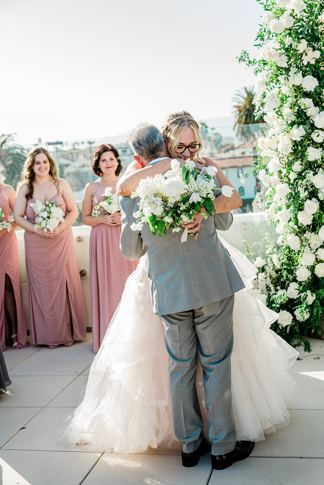 Romantic picture of Bride, hugging Groom during her luxury wedding in Santa Barbara, California