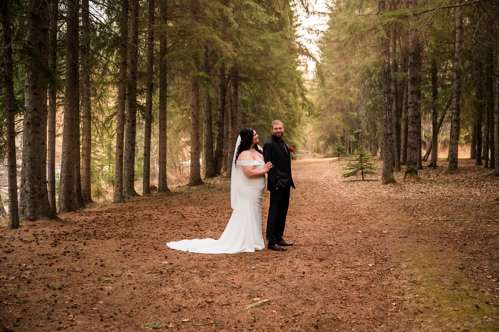 bride and groom in a forest near Rocky Mountain House, Alberta