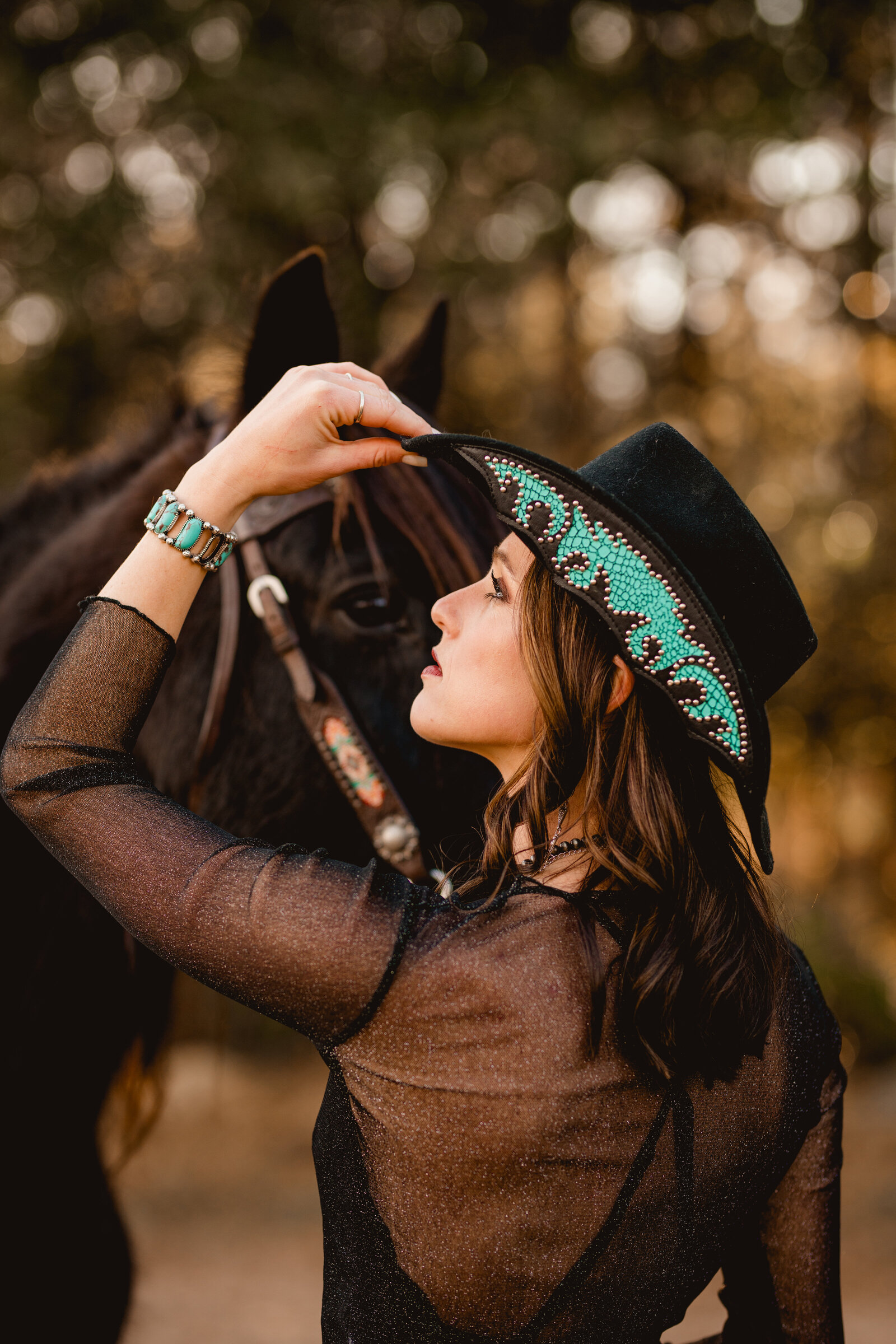 Cowgirl poses in Tallahassee, FL at sunset for horse and rider photoshoot.