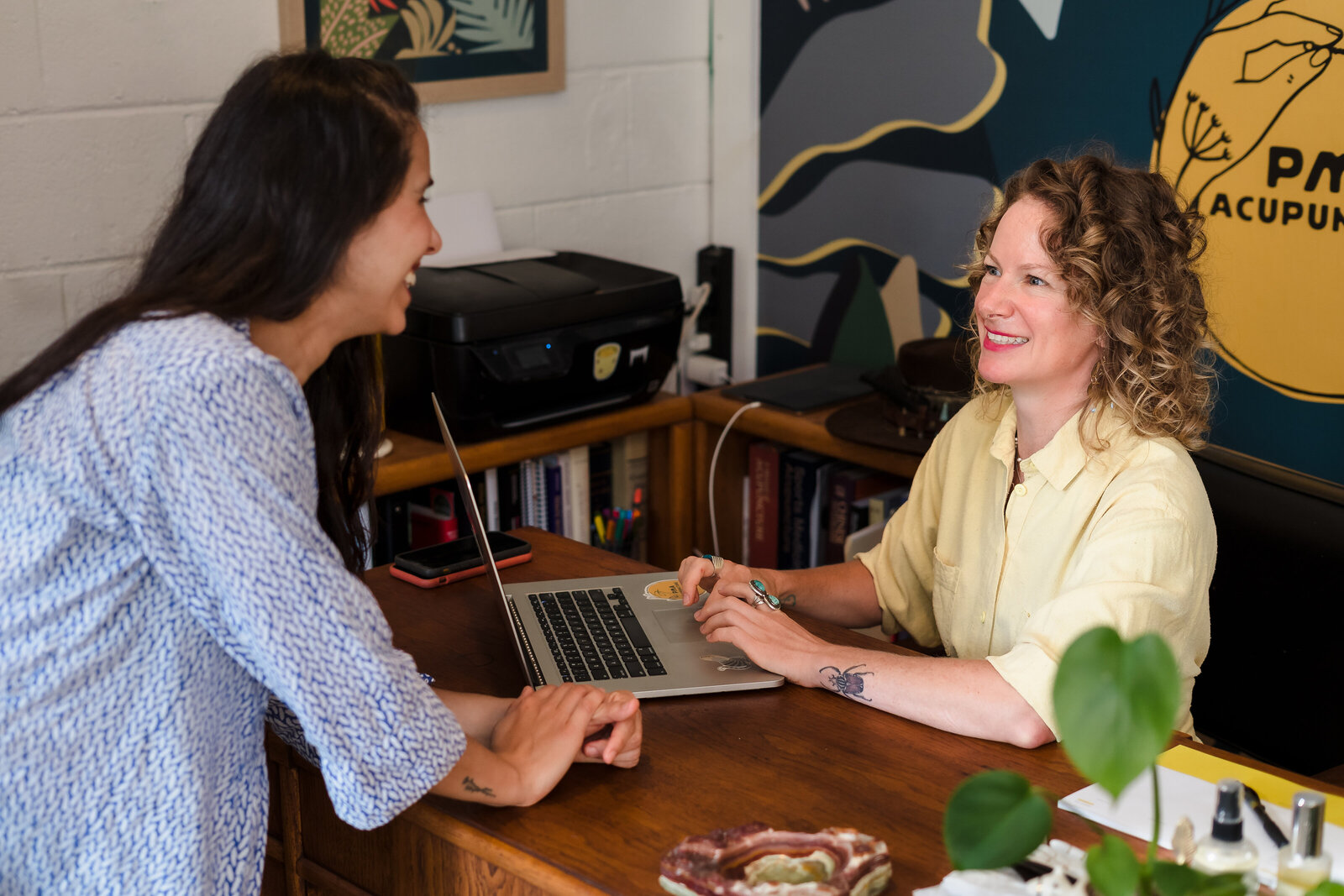 small business owner seated in her desk, talking to a client
