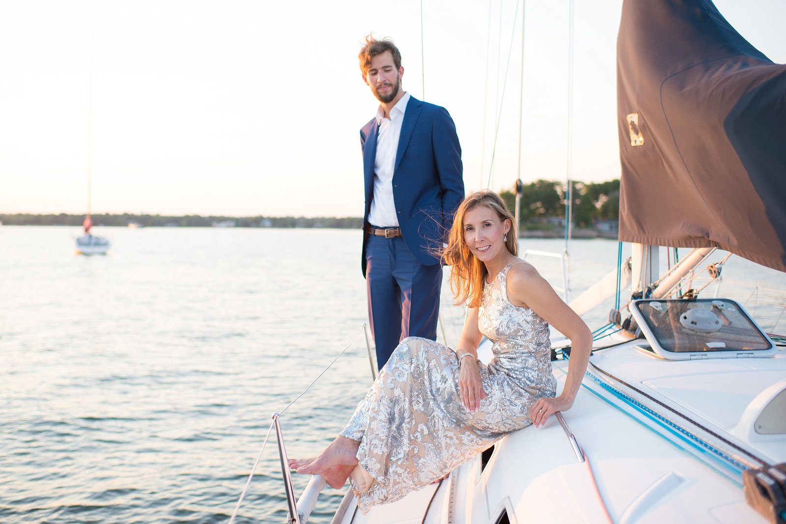 Bride and Groom on sailboat and water during sunset at The American Yacht Club in Rye, New York Photo