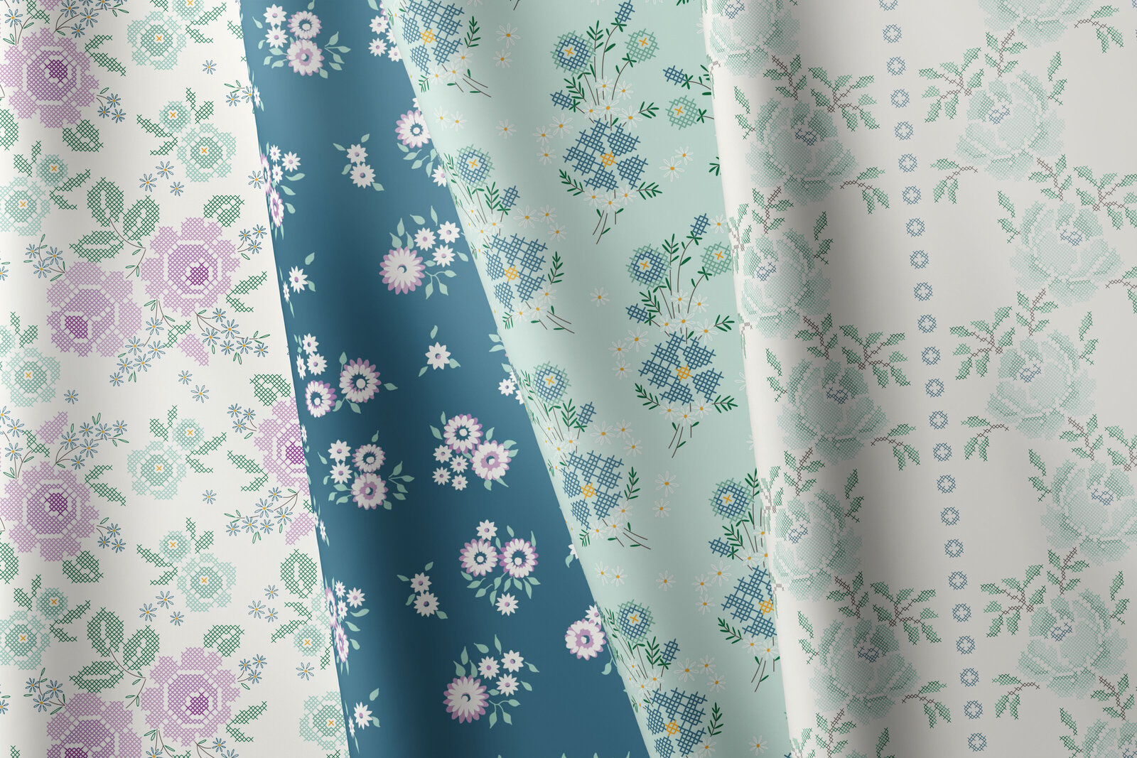 Four pieces of floral fabric laying on top of eachother.