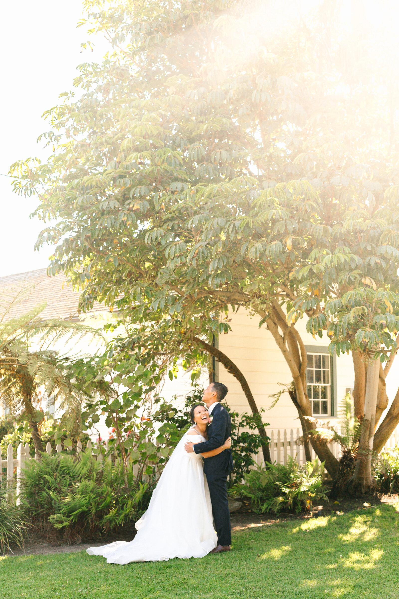 A bride and groom share a laugh before their wedding reception.
