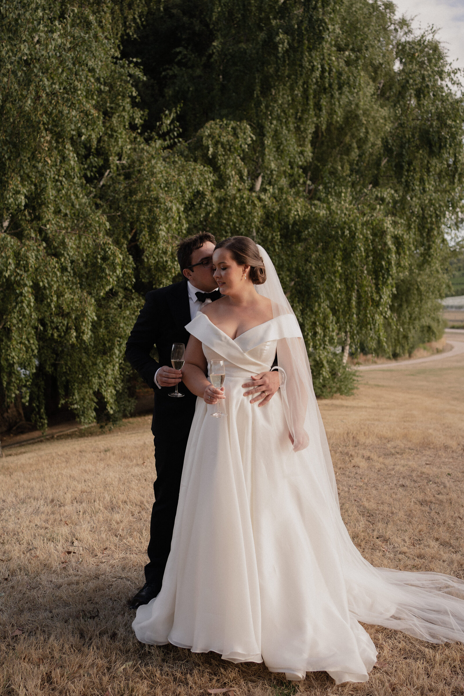 Bride and Groom at Summergrove Estate in the grass