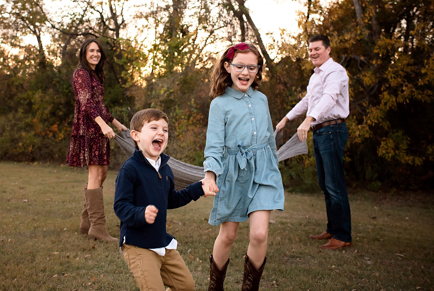 Two young kids laughing and having fun at their outdoor lifestyle family session in Allen, TX.