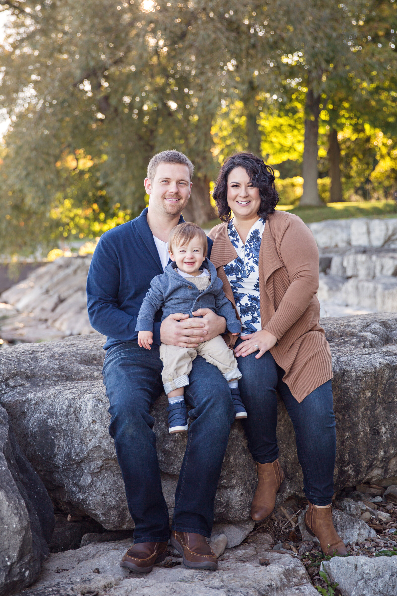 family sitting on the rocks at Paletta Mansion