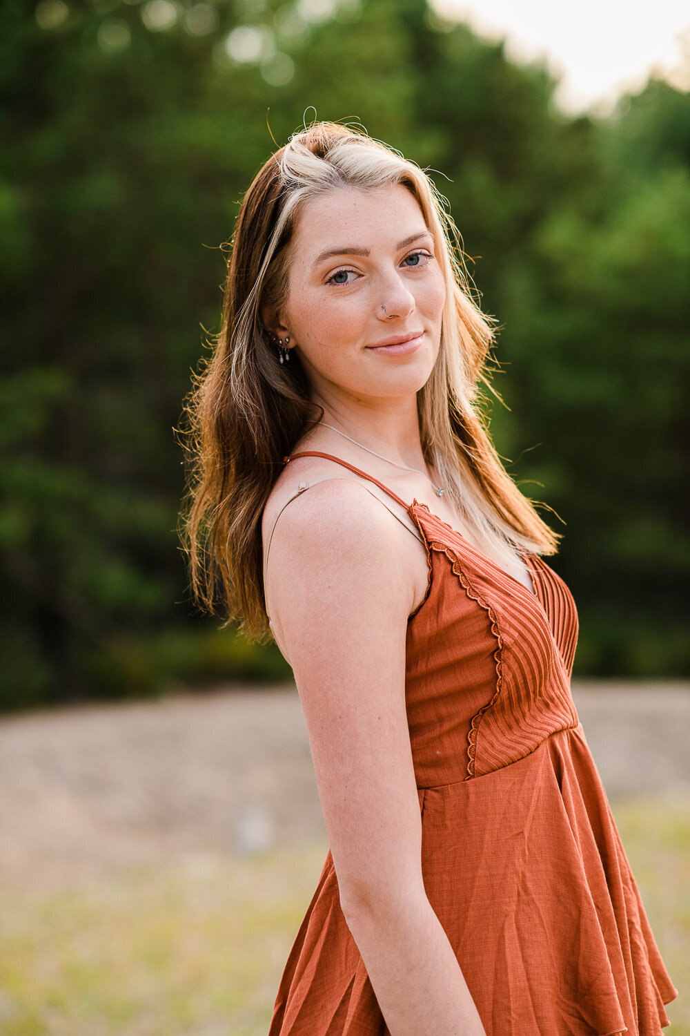 grad girl in sun by trees