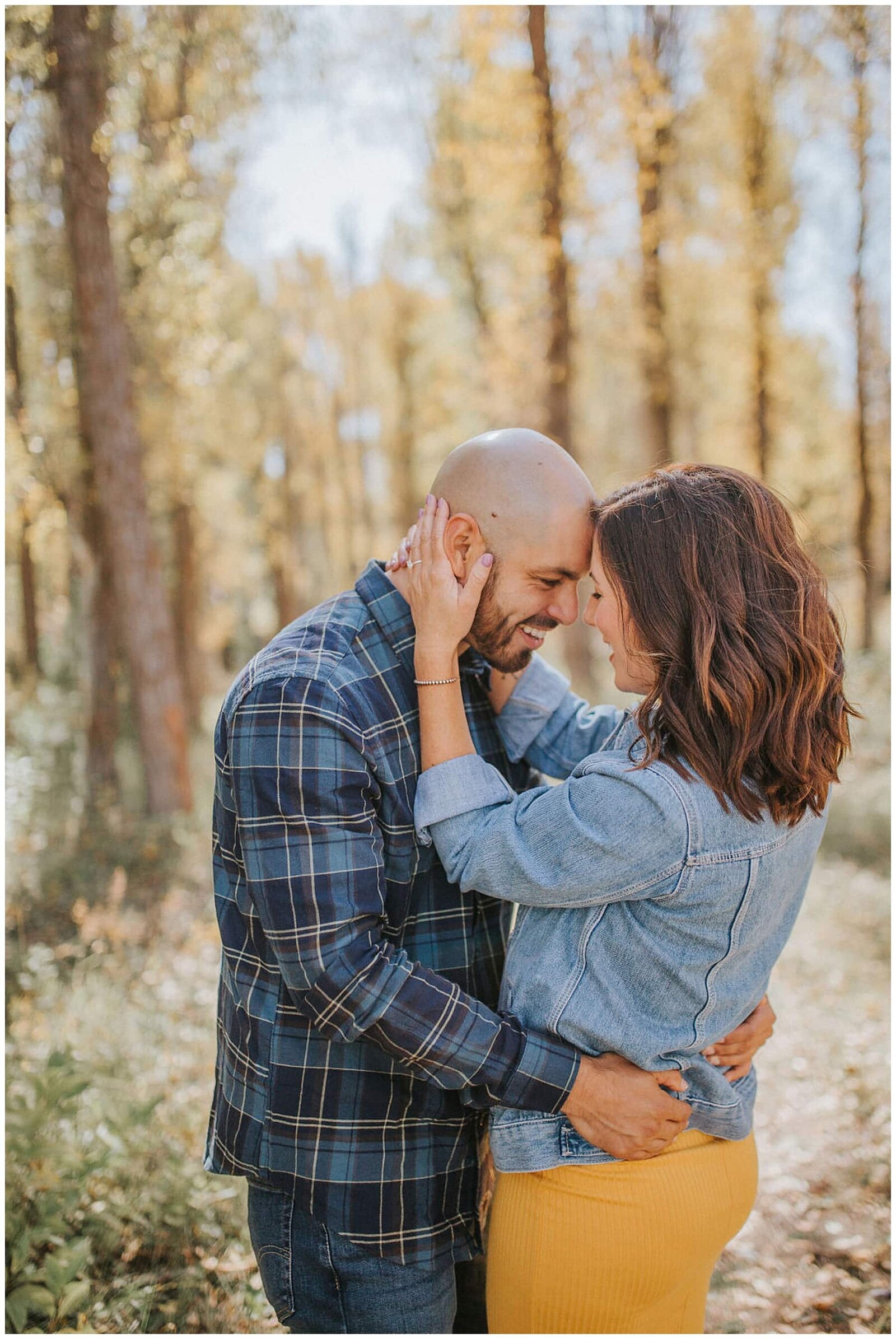 Lake Tahoe wedding photographer captures couple hugging during forest engagements