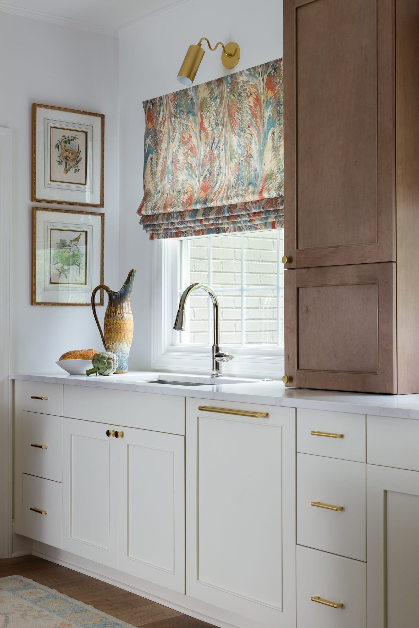 melinda chesson interiors poindexter kitchen sink with white cabinets and colorful curtains over window