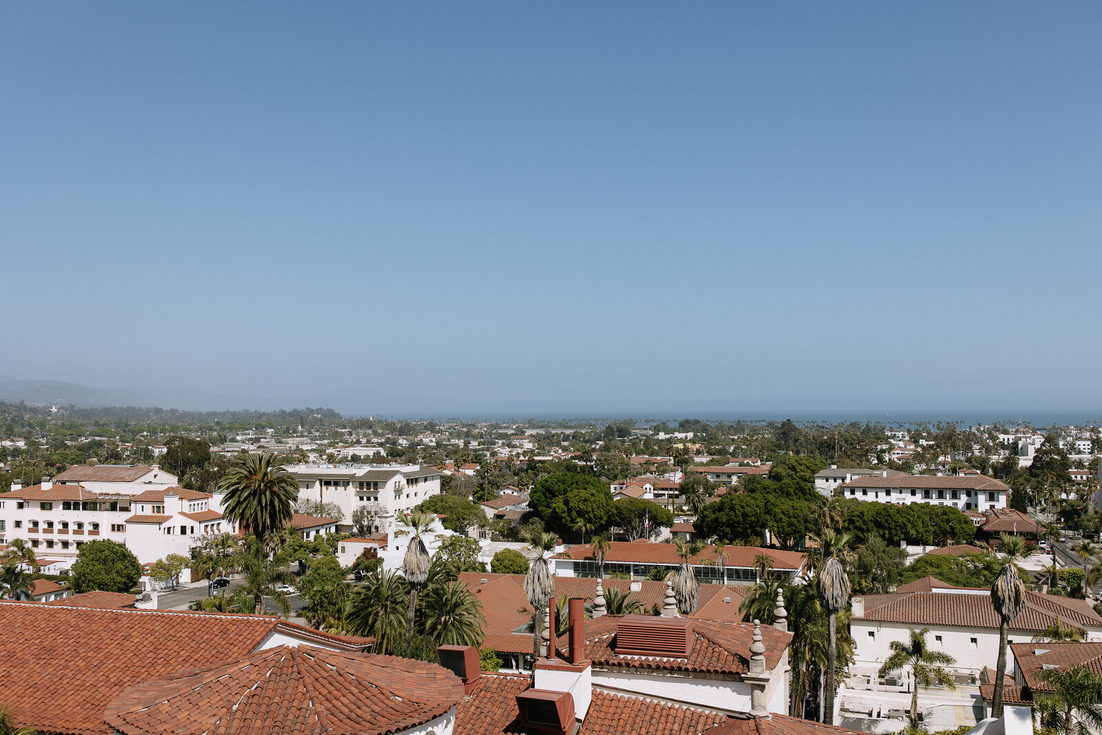 Palm trees and clock tower framed from Santa Barbara Courthouse balcony, taken by California wedding photographer