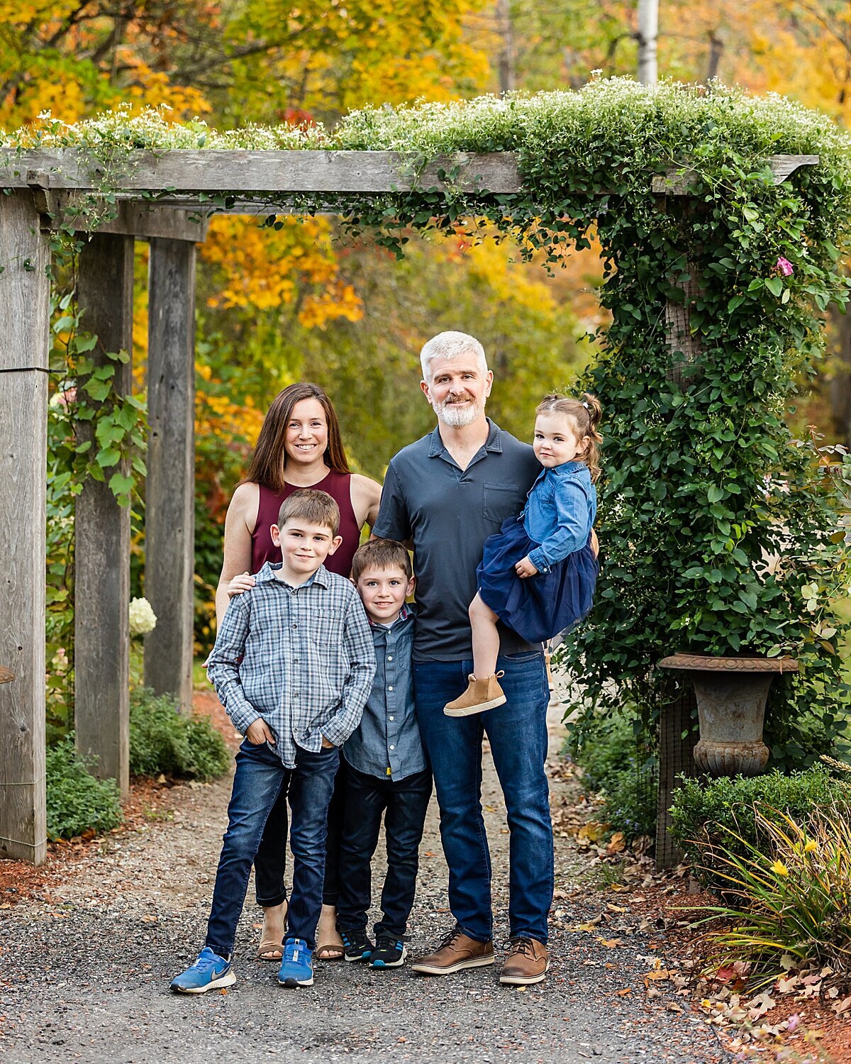 Family of 5 smiles during their fall family photo session in Bedford, New Hampshire