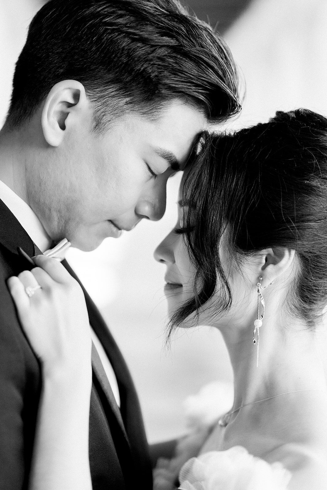 The bride and groom share an intimate and tender moment at their wedding at the iconic Stanford Memorial Church in California.