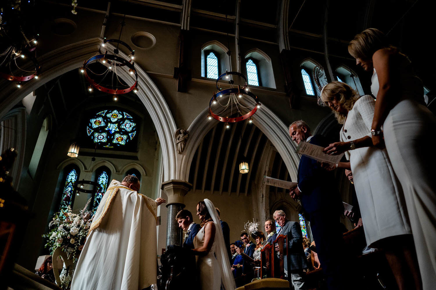 a vicar gives his blessing to a wedding couple in a church wedding