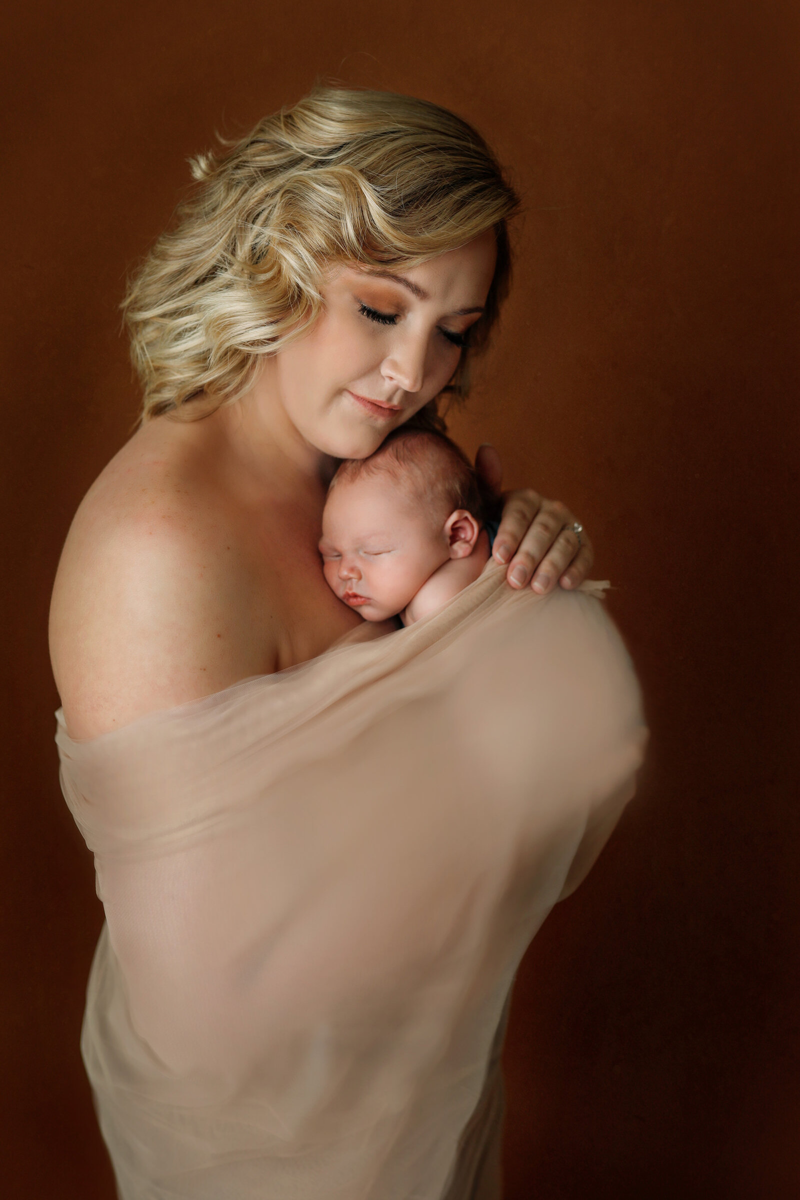new-mom-holding-baby-blue-snuggling-baby- neutrals- beauty