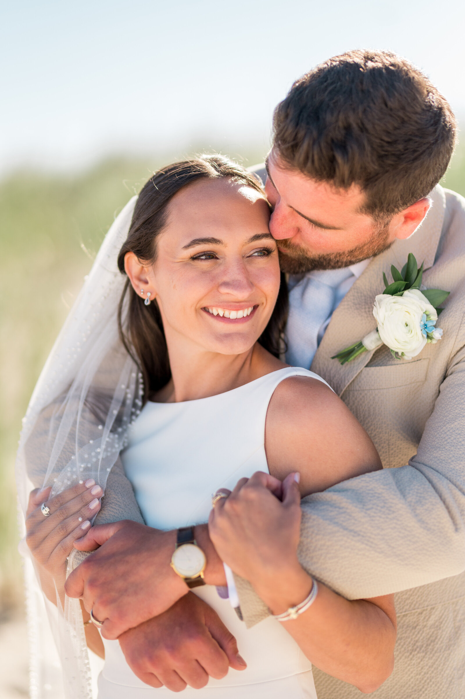 Joyful close-up of bride and groom embracing at coastal Cape Cod wedding — warm, bright, airy photography by Sarah Surette Photography.