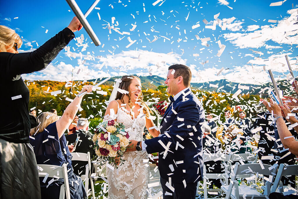 Couple with confetti during wedding ceremony exit