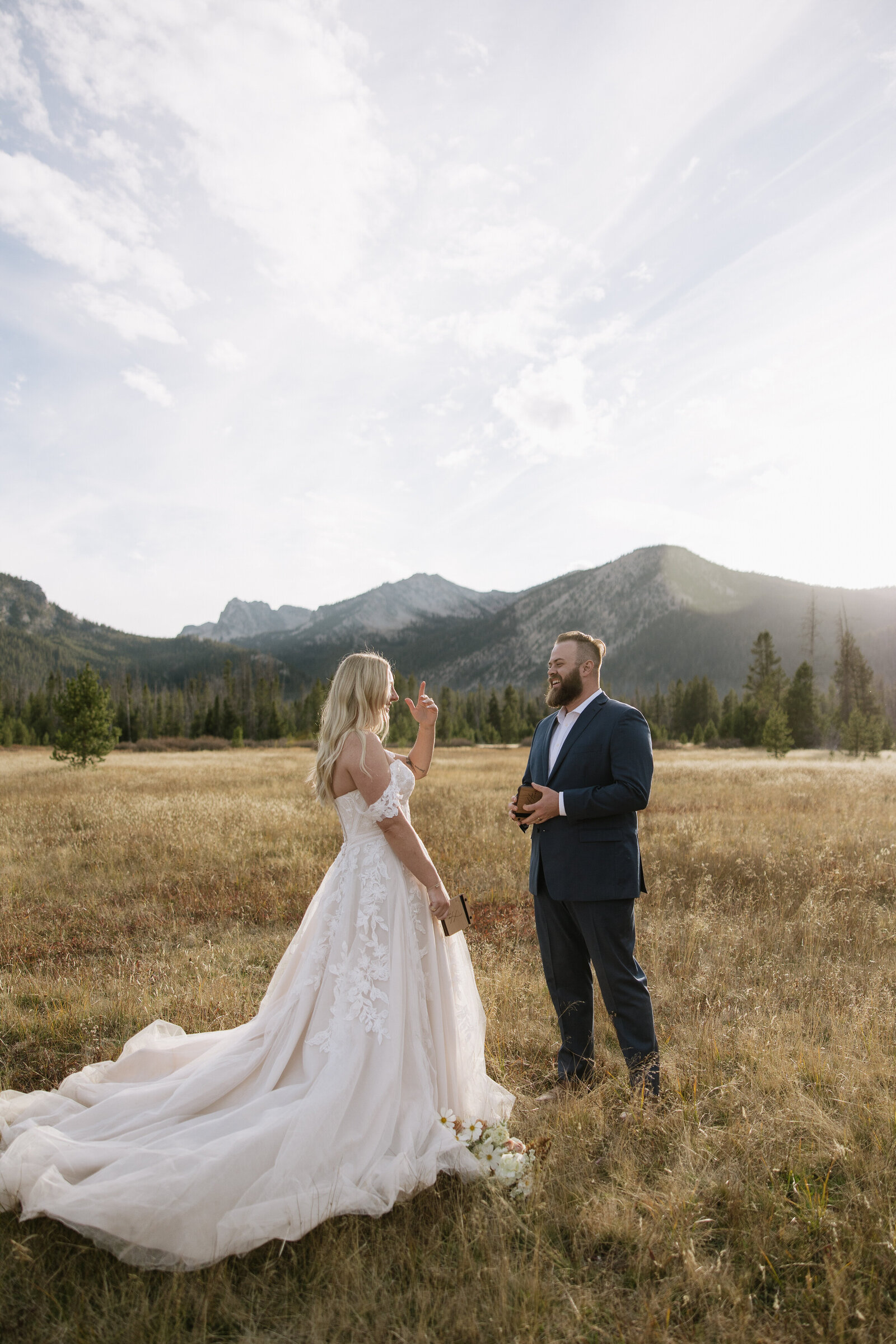 Bride and groom laugh during their first look at elopement in Stanley, Idaho