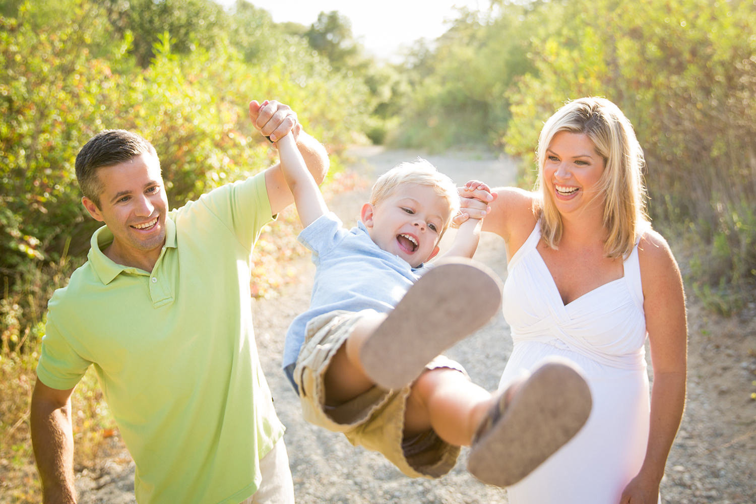 san diego family photographer | mom and dad swinging child and laughing