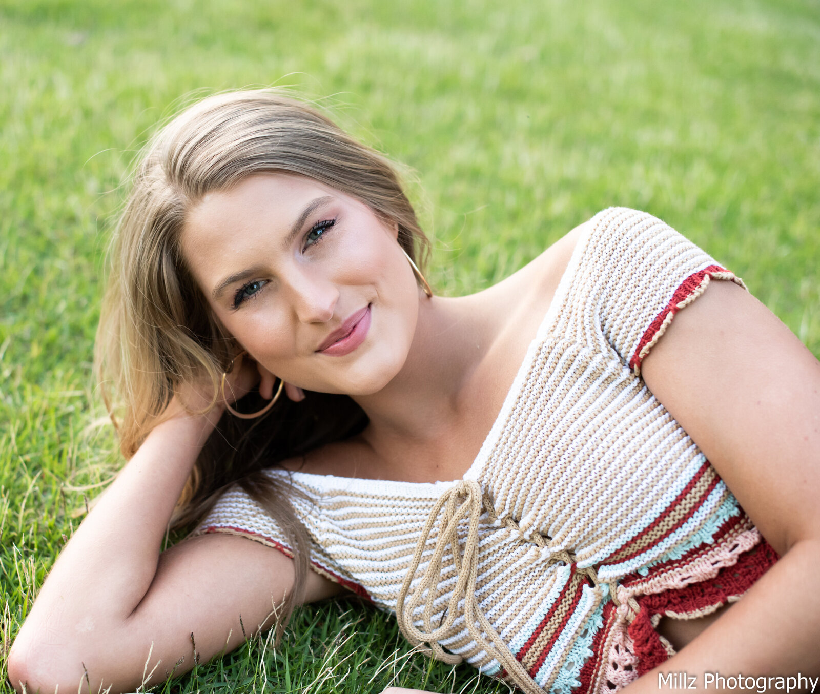 a girl laying in the grass photographed by Millz Photography in Greenville, SC