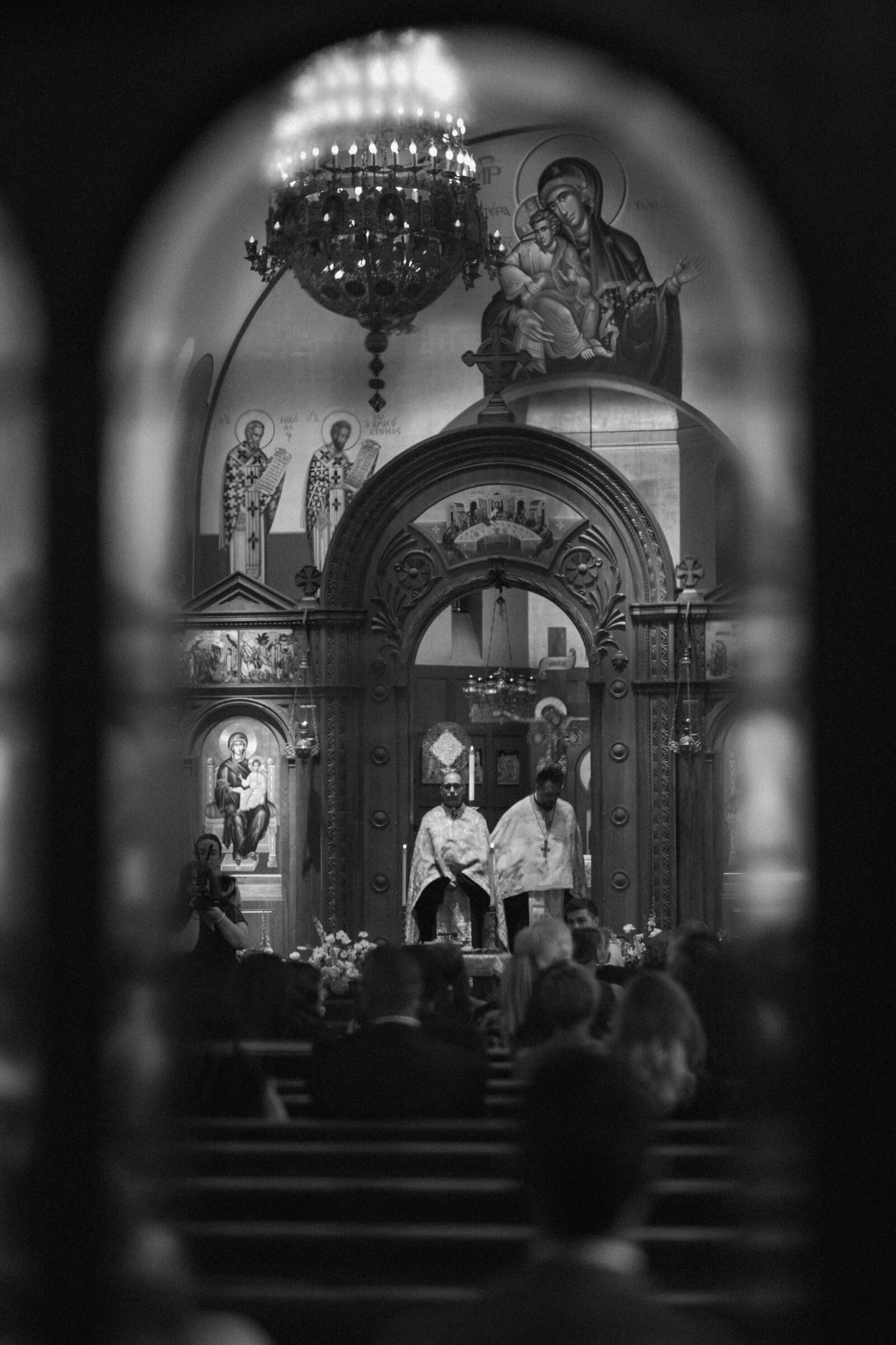 black & white photo looking through glass in a  cathedral