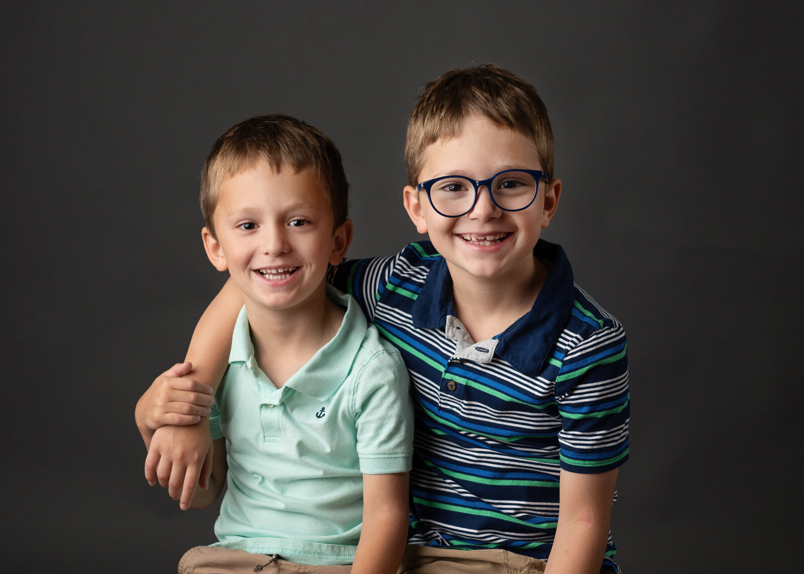 Two young brothers smiling for their school picture.